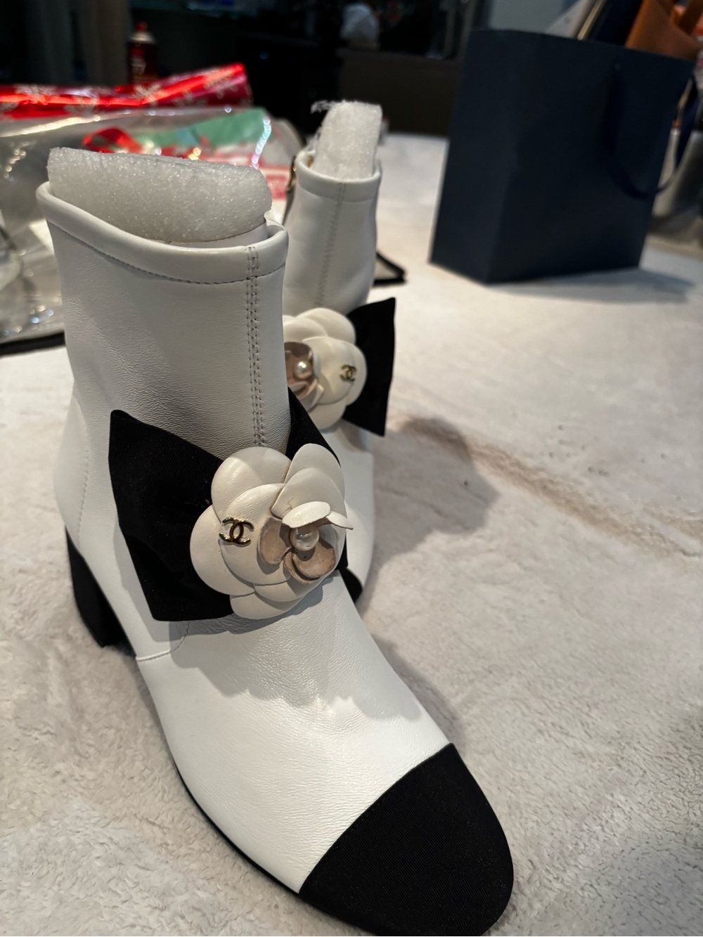 CHANEL White Leather Ankle Boots with Black Cap Toe & Camellia